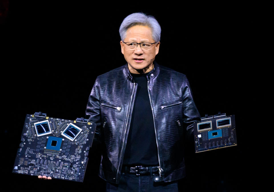 NVIDIA CEO Jensen Huang shows off products on stage during the annual Nvidia GTC Artificial Intelligence Conference at the SAP Center in San Jose, California, on March 18, 2024. (Photo by JOSH EDELSON / AFP) (Photo by JOSH EDELSON/AFP via Getty Images )